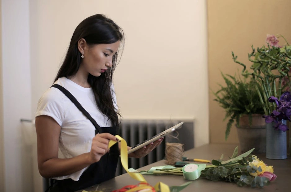 A professional retail consultant analyzing a store's performance data on a tablet.